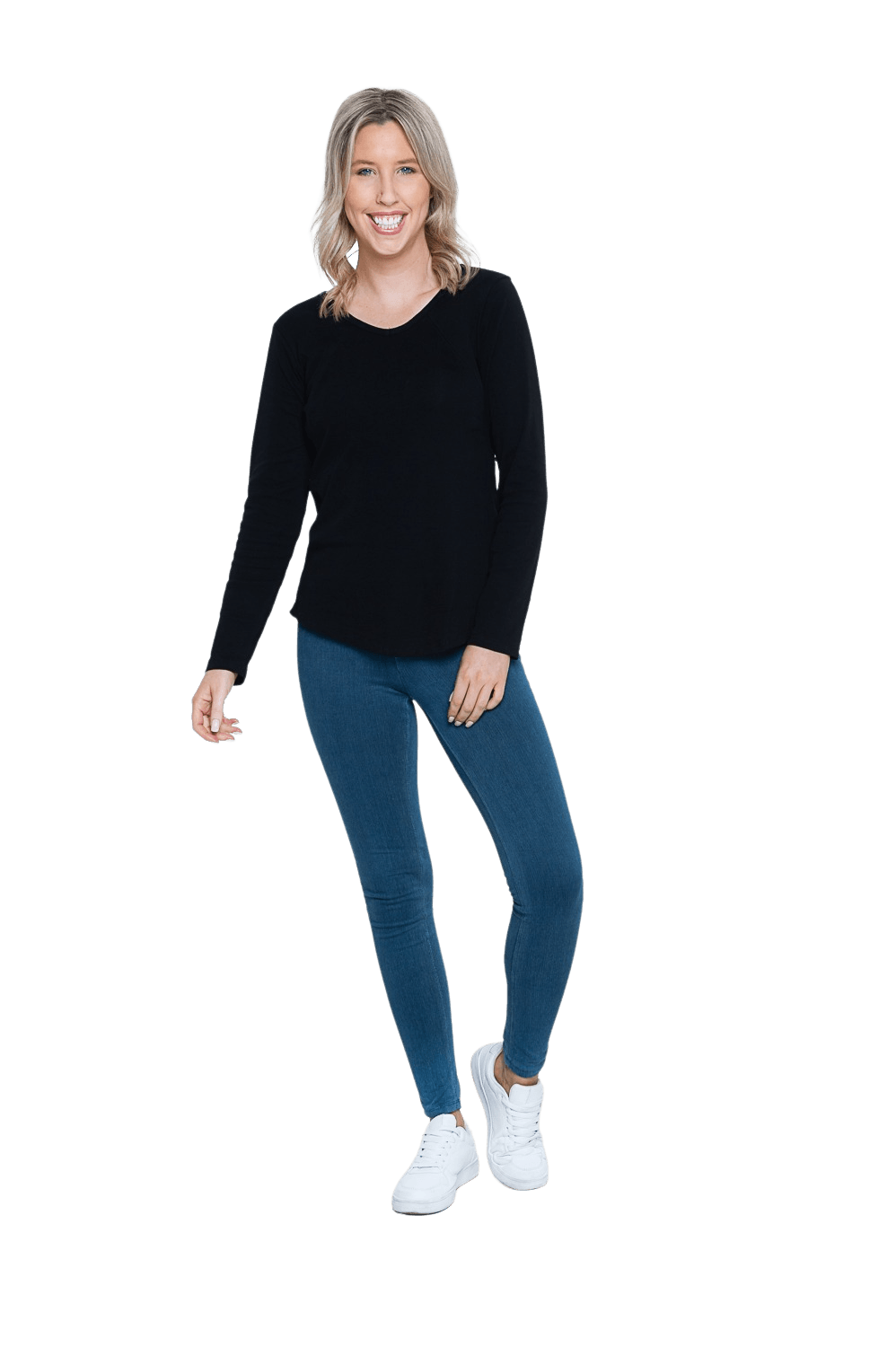 Petite model facing camera wearing black long sleeved top, featuring soft V-neck and a scooped hem. Reese available in sizes 6-26
