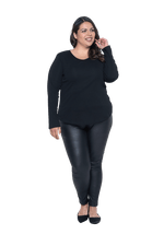 Curvy model facing camera wearing black long sleeved top, featuring soft V-neck and a scooped hem. Reese available in sizes 6-26