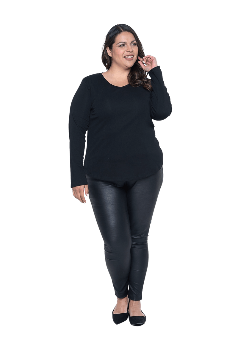 Curvy model facing camera wearing black long sleeved top, featuring soft V-neck and a scooped hem. Reese available in sizes 6-26
