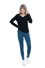Petite model facing the camera wearing black long sleeved top tied at the hip, featuring soft V-neck and a scooped hem. Reese available in sizes 6-26