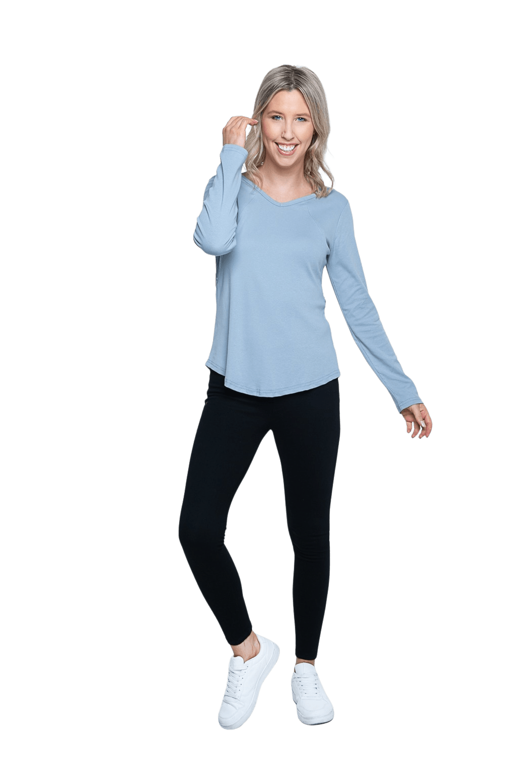 Petite model facing camera wearing dusty blue long sleeved top, featuring soft V-neck and a scooped hem. Reese available in sizes 6-26