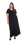 Curvy model facing camera wearing black maxi dress, featuring  rounded neckline, and a gently fitted bodice, gathering above the waist. Riley available in sizes 6-26