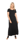 Petite model facing the camera wearing black maxi dress, featuring  rounded neckline, and a gently fitted bodice, gathering above the waist. Riley available in sizes 6-26