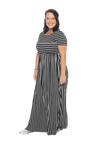 Brunette model facing the side wearing black and white striped maxi dress, featuring rounded neckline, and a gently fitted bodice, gathering above the waist. Riley available in sizes 6-18