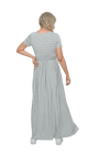 Petite model facing the back wearing light grey and white striped maxi dress, featuring rounded neckline, and a gently fitted bodice, gathering above the waist. Riley available in sizes 6-18