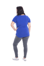 Petite model facing the back wearing cobalt blue short sleeved tee, featuring rounded neckline, and scooped hem. Stevie available in sizes 6-18
