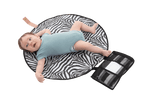 The All Rounder Change Mat shown laying flat with a baby lying on top. Baby has brown hair and wears blue short sleeves onesie. His tiny little toes and fingers are so cute!