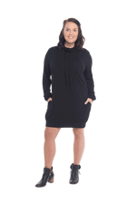 Brunette model facing the camera wearing black long sleeved tunic as a dress with boots, featuring pockets and a faux hoodie collar in a comfy, relaxed fit. Tori available in sizes 6-18