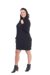 Brunette model facing the side wearing black long sleeved tunic, featuring pockets and a faux hoodie collar in a comfy, relaxed fit. Tori available in sizes 6-18