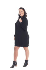 Brunette model facing the side wearing black long sleeved tunic, featuring pockets and a faux hoodie collar in a comfy, relaxed fit. Tori available in sizes 6-18
