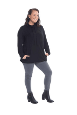 Brunette model facing the camera wearing black long sleeved tunic as a top with jeans, featuring pockets and a faux hoodie collar in a comfy, relaxed fit. Tori available in sizes 6-18