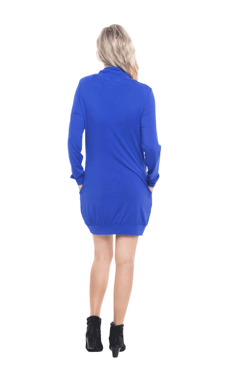 Petite model facing the back wearing cobalt blue long sleeved tunic as a dress with boots, featuring pockets and a faux hoodie collar in a comfy, relaxed fit. Tori available in sizes 6-18