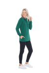 Petite model facing the side wearing bottle green long sleeved tunic as a top with black pants, featuring pockets and a faux hoodie collar in a comfy, relaxed fit. Tori available in sizes 6-26