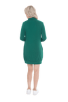Petite model facing the back wearing bottle green long sleeved tunic as a dress with sneakers, featuring pockets and a faux hoodie collar in a comfy, relaxed fit. Tori available in sizes 6-26