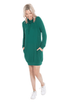 Petite model facing the camera wearing bottle green long sleeved tunic as a dress with sneakers, featuring pockets and a faux hoodie collar in a comfy, relaxed fit. Tori available in sizes 6-26