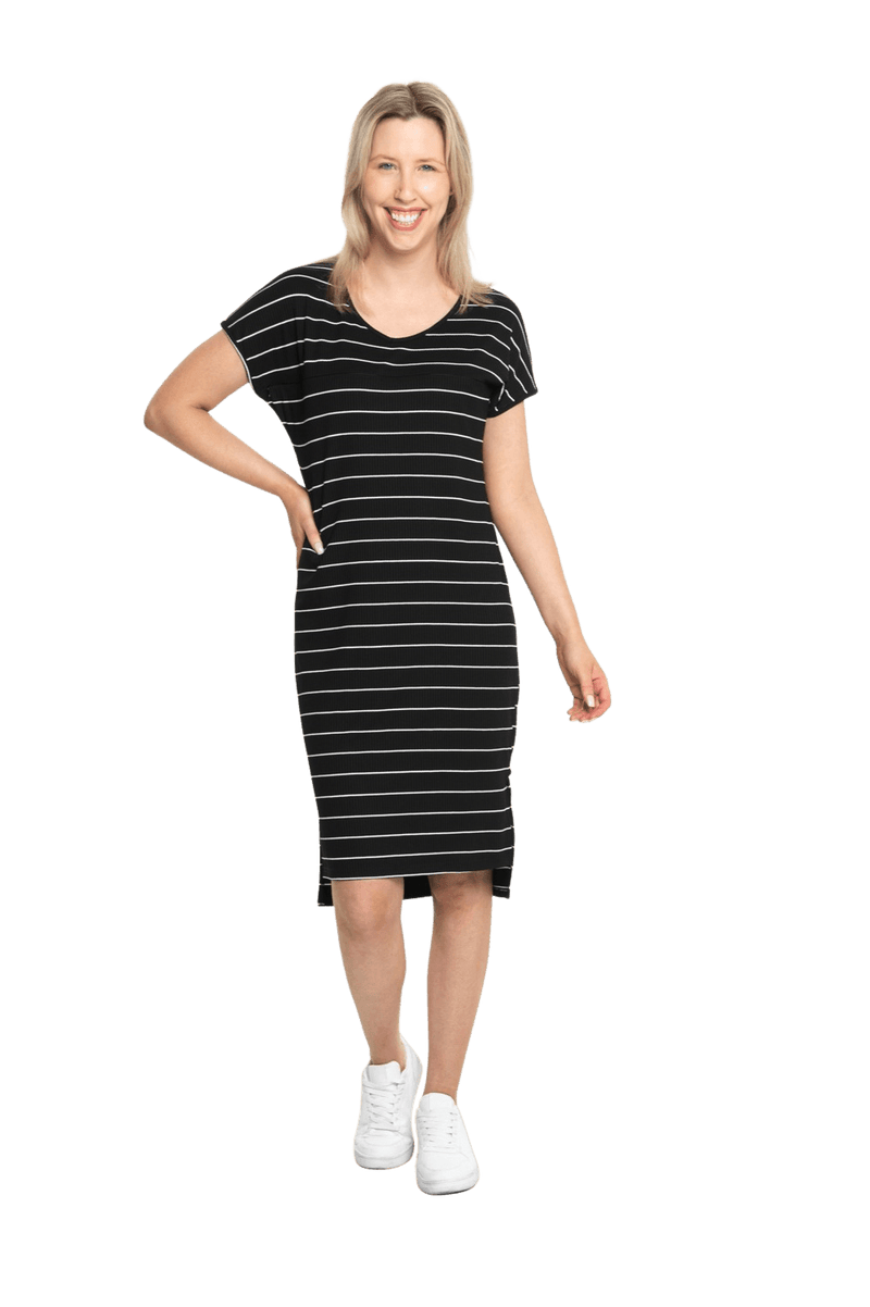 Petite model facing the camera wearing black with white pin striped shift dress, featuring slight v neck and side splits. Zoe available in sizes 6-18