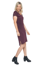 Petite model facing the side wearing maroon with white pin striped shift dress, featuring slight v neck and side splits. Zoe available in sizes 6-18