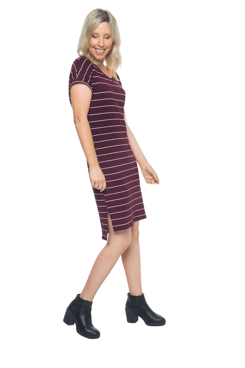 Petite model facing the side wearing maroon with white pin striped shift dress, featuring slight v neck and side splits. Zoe available in sizes 6-18