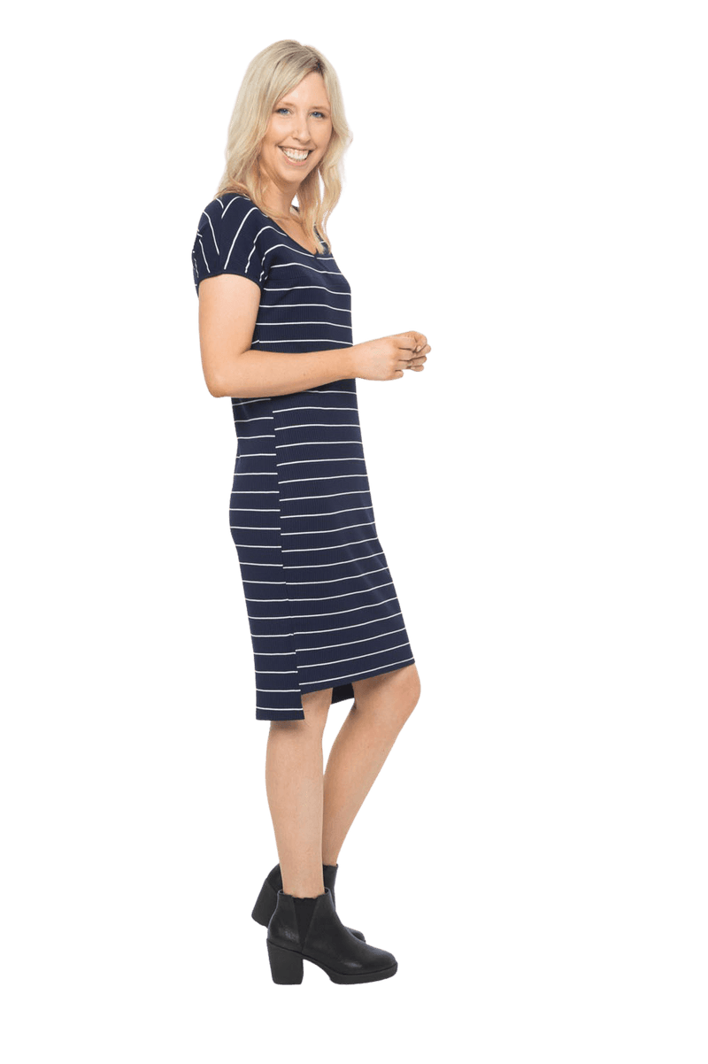 Petite model facing the side wearing navy with white pin striped shift dress, featuring slight v neck and side splits. Zoe available in sizes 6-18